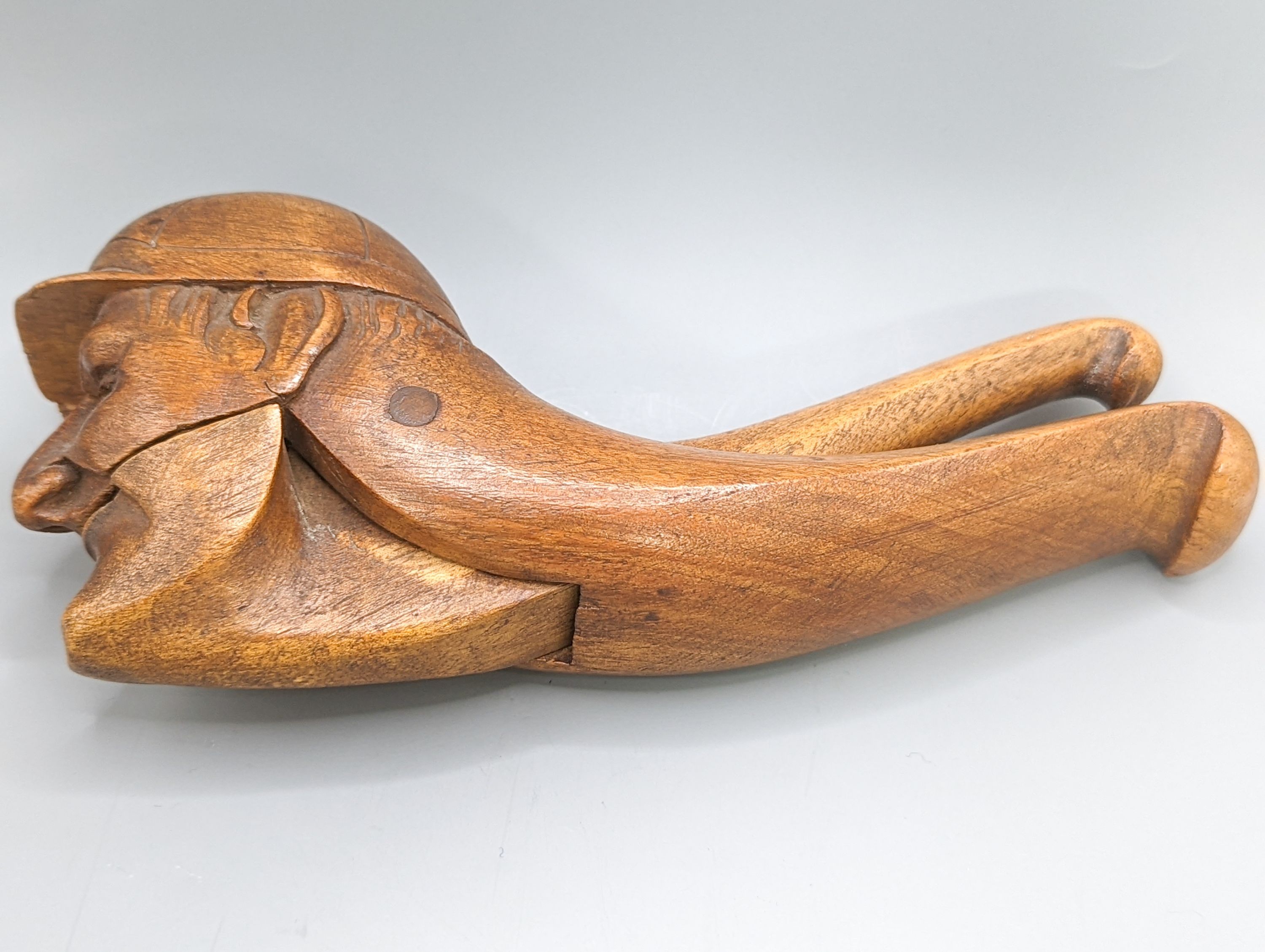 A pair of Victorian treen nutcrackers, in the form of a jockey’s head, glass in set eyes, length 20cm